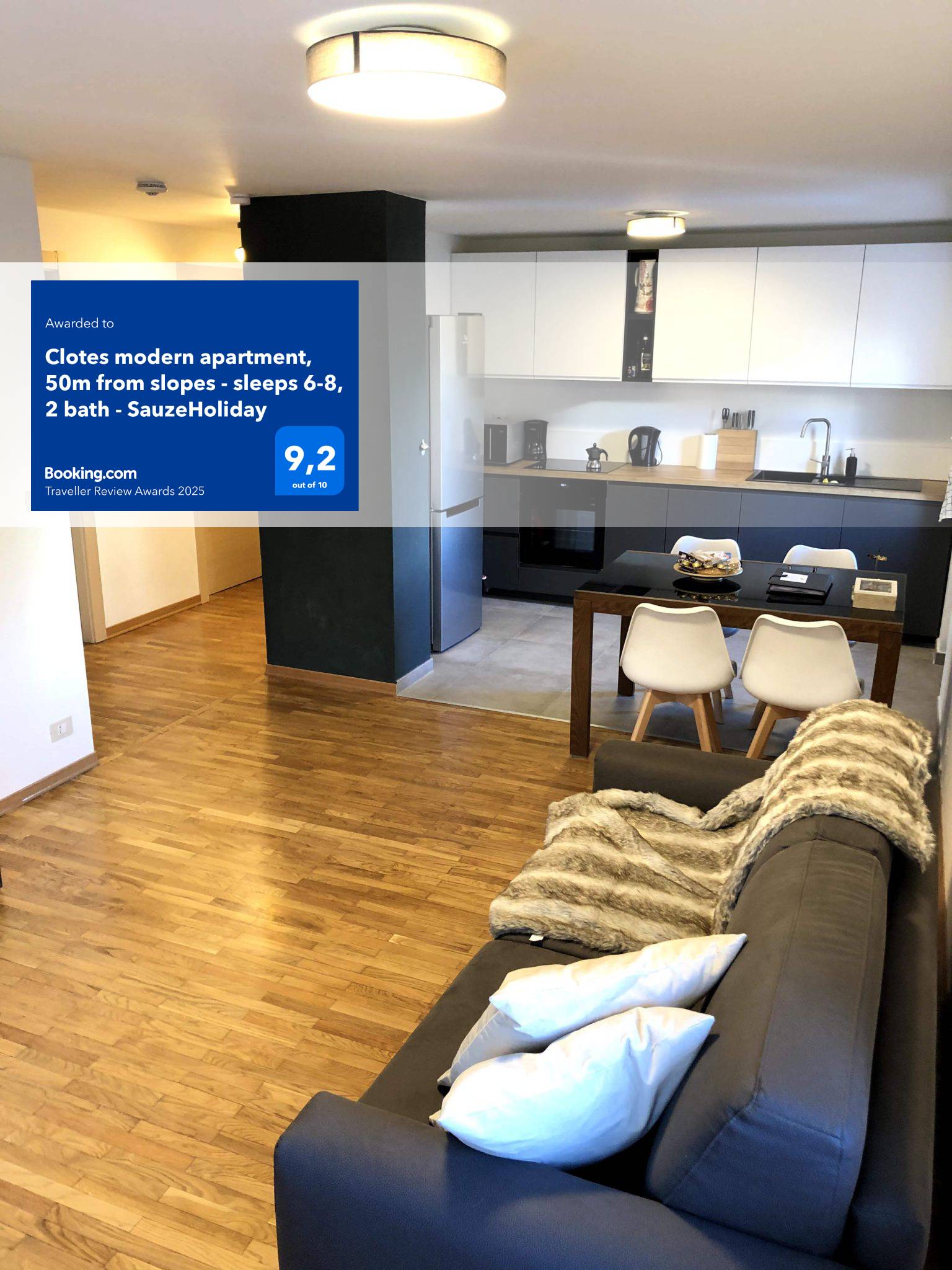 Modern apartment living room and kitchen with a blue Booking.com award badge overlay